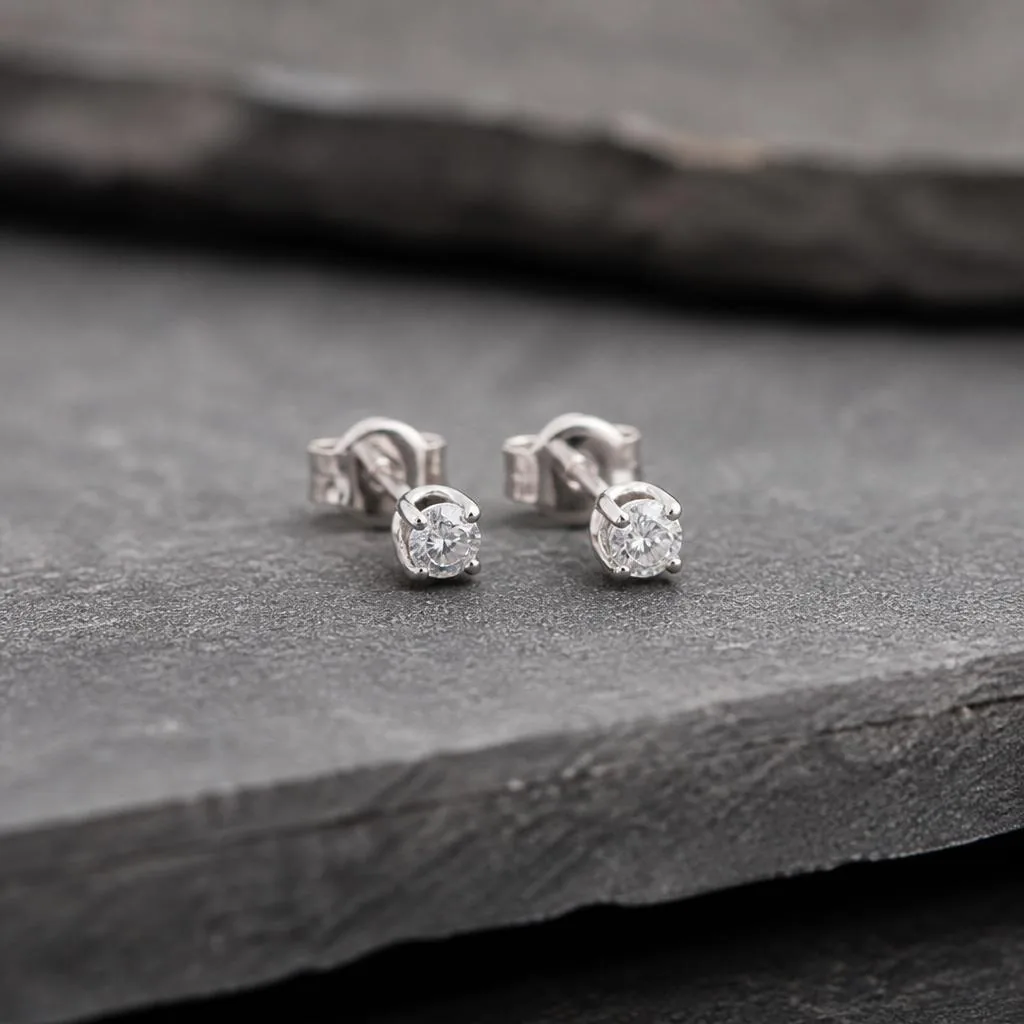 Minimal white gold diamond studs on grey stone